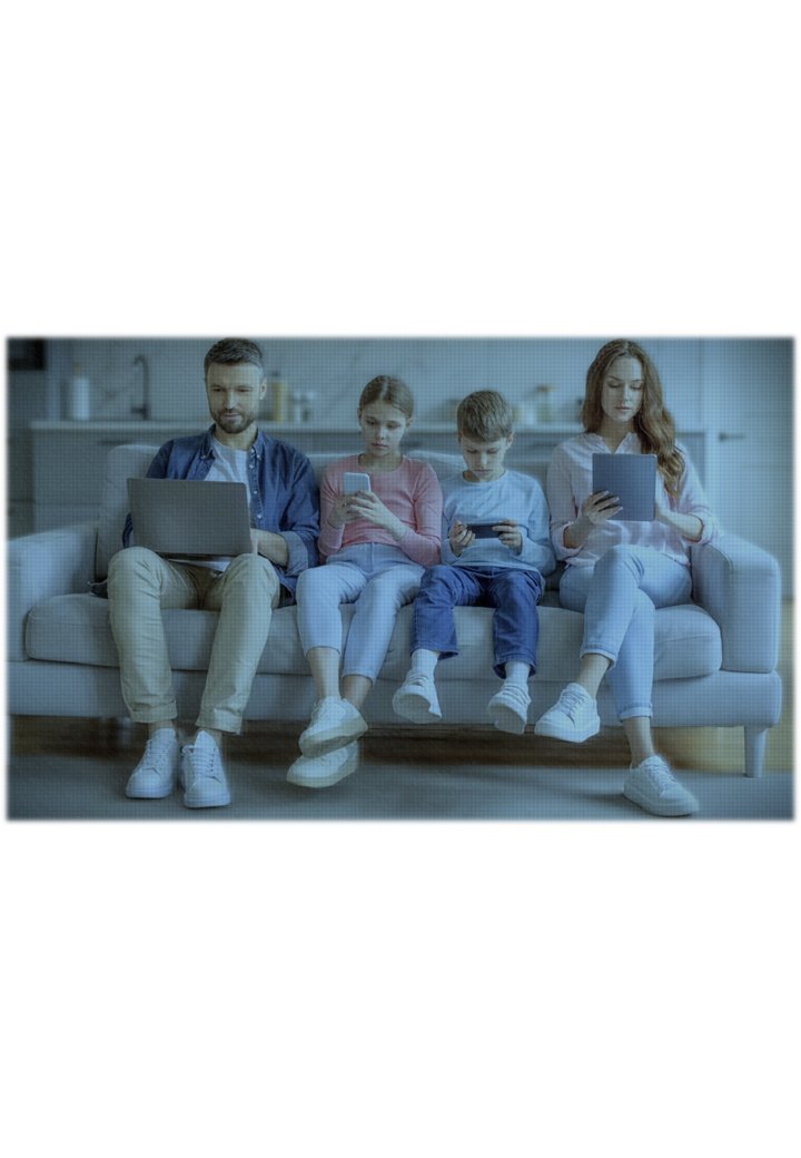 Happy family on couch with devices